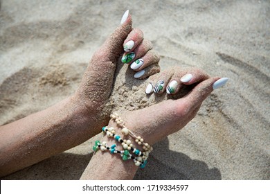 Sand In A Women Hands On The Beach.Travel And Vacation Concept