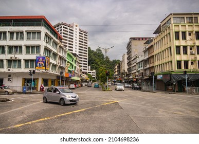 Sandakan, Malaysia - January 06, 2022: Cityscape of the Borneo town. Rundown houses and old Malaysian cars on the street. Second largest city of Sabah and formerly known as Elopura. City view Sandakan