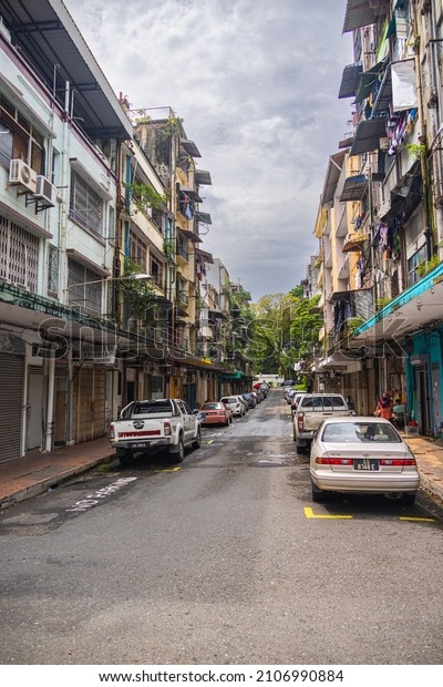 Sandakan, Malaysia - January 06, 2022: Cityscape\
of the in Borneo. Rundown houses and old Malaysian cars on the\
street. Second largest city of Sabah and formerly known as Elopura.\
City view Sandakan