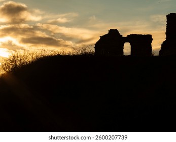 Sandal castle ruins silhouette in Yorkshire at sunset wide landscape wide shot selective focus