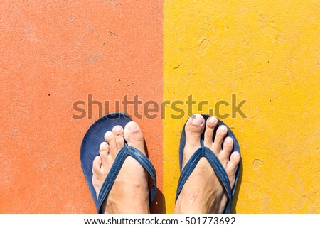 sandal on street with orange and yellow cement background