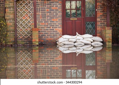 Sandbags Outside Front Door Of Flooded House - Shutterstock ID 344300294