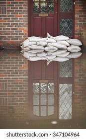 Sandbags Outside Front Door Of Flooded House