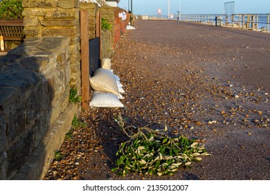 Sandbags Piled Against Garden Gates, Storm Surge Flood Defences On The Seafront At Bexhill-on-Sea In The United Kingdom