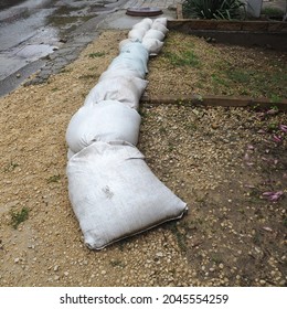 Sandbags Are Placed On The Ground Next To The Road To Prevent Flooding And Overflow. Home Protection From Bad Weather, Cyclone And Hurricanes. Insurance Case. Anapa, Krasnodar, Russia, August 2021