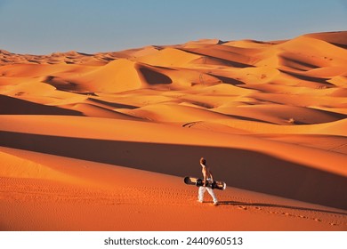 Sandboarding the dunes in the desert - Powered by Shutterstock