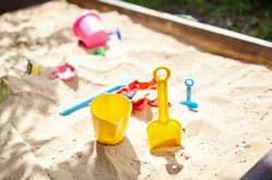 Sandbox Outdoor. Children's Wooden Sandbox With Various Toys For The Game. Summer Concept. Selective Focus With Shallow Depth Of Field