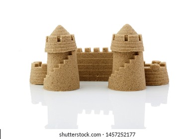 Sandcastle at the beach isolated over white