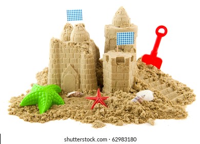 Sandcastle at the beach on vacation isolated over white