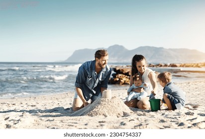 Sandcastle, happy summer and children at the beach with bonding, love and support. Baby, mom and dad together with kids playing in the sun with mockup space and smile by the ocean and sea with family - Powered by Shutterstock