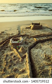 Sandcastle With Moat On The Baltic Beach At Dusk. Summer Vacation, Leisure Activity. Pomerania, Poland.