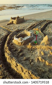 Sandcastle With Moat On The Baltic Beach At Dusk. Summer Vacation, Leisure Activity. Pomerania, Poland.