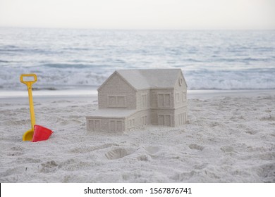 Sandcastle in the shape of house on beach