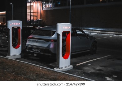 Sandefjord, Norway - februar 25, 2022: Silver Mercedes EQC Parked At Tesla Supercharger Station. The Mercedes EQC Is A Full-sized All-electric Five-door SUV
