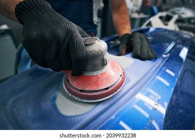 Sander Grinding Painted Bumper In Car Workshop