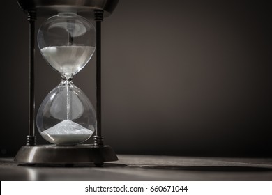 Sandglass, hourglass or egg timer with shadow showing the last second or last minute or time out. With copy space. Time management. 
