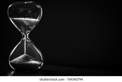 A sandglass, modern hourglass or egg timer showing the last second or last minute or time out. With copy space.