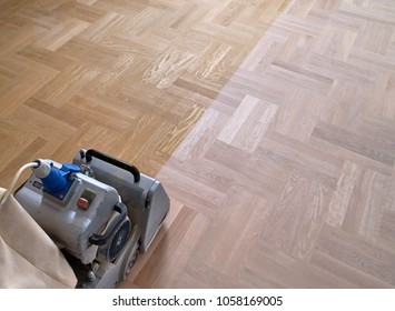 Sanding hardwood floor with the grinding machine. Repair in the apartment. Carpenter doing parquet wood floor polishing maintenance work by grinding machine - Shutterstock ID 1058169005
