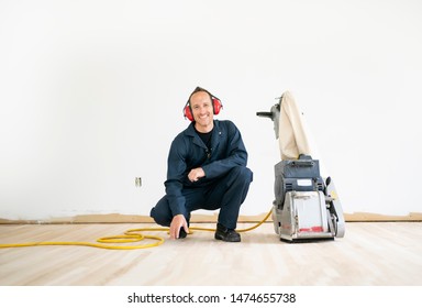 A Sanding Hardwood Floor With The Grinding Machine.