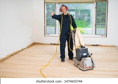 A Sanding Hardwood Floor With The Grinding Machine.