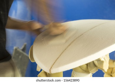 Sanding/ A Surfboard Maker Sands A Foam Core Into Shape