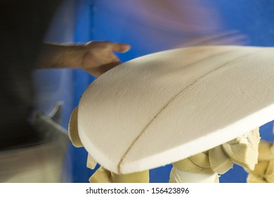 Sanding/ A Surfboard Maker Sands A Foam Core Into Shape