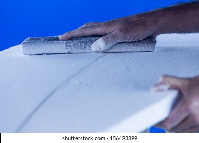 Sanding/ A Surfboard Maker Sands A Foam Core Into Shape