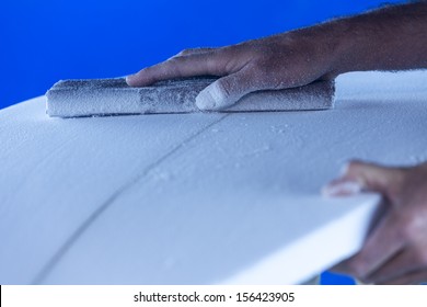 Sanding/ A Surfboard Maker Sands A Foam Core Into Shape