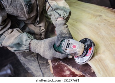 Sanding wood sander. A man working with grinder. Sawdust flew from under the wheel. - Powered by Shutterstock