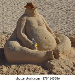 Sandman Holding A Bottle In The Beach