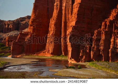 Sandstone cliffs towering above a river on the Quebrada de las Conchas, or Quebrada de Cafayate, Salta Province, northwest Argentina.