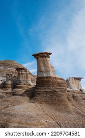 Sandstone pillars with rock caps, also known as The Hoodoos, in Drumheller, Alberta, Canada.Hoodoos are tall rock pillars created from soft sedimentary rock (sandstone) topped with a harder rock.
