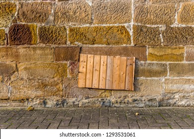 Sandstone Wall With Cellar Window And Shaft For Potato Or Coal Cellar, Covered With Board Made Of Wood Panels