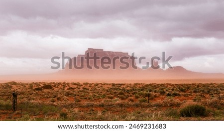 Similar – Image, Stock Photo Dramatic storm over Monument Valley road