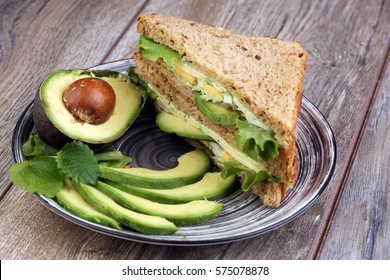 Sandwich With Avocado And Poached Egg - Healthy Breakfast Concept