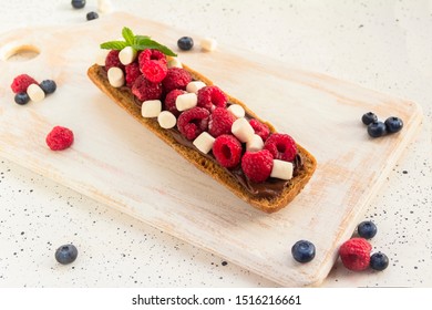 Sandwich With Berries And Nut Paste. Healthy Breakfast Toasts With Peanut Butter, Blackberry, Blueberry, Raspberry, Marshmellow, Mint. Silver Spoon. Vertical. Copy Space. 