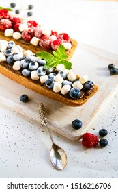 Sandwich With Berries And Nut Paste. Healthy Breakfast Toasts With Peanut Butter, Blackberry, Blueberry, Raspberry, Marshmellow, Mint. Silver Spoon. Vertical. Copy Space. 

