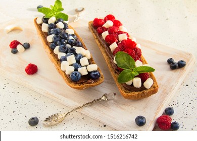 Sandwich With Berries And Nut Paste. Healthy Breakfast Toasts With Peanut Butter, Blackberry, Blueberry, Raspberry, Marshmellow, Mint. Silver Spoon. Horizontal. Copy Space. 