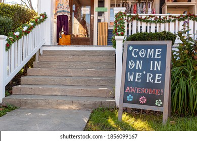 A Sandwich Board With A Welcoming Notice On It Which Reads : 