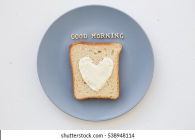 sandwich for breakfast in the form of heart with cheese on a blue plate inscription good morning - Powered by Shutterstock