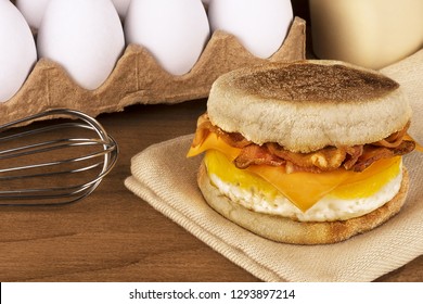 Sandwich Breakfast With Ingredients In Background. English Muffin, Egg, Cheese And Bacon.