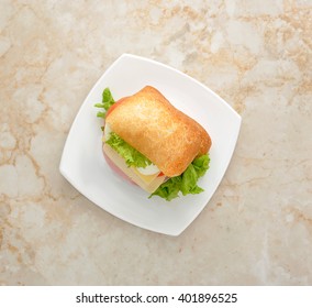 Sandwich With Cheese, Egg And Ham On White Plate. Top View