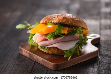 sandwich with cheese, ham and arugula
