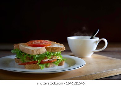 Sandwich Cheese And Thick Ham With Veg. In White Dish And Black Coffee All Put On Wooden Chopping Board / Select Focus, Space For Text

