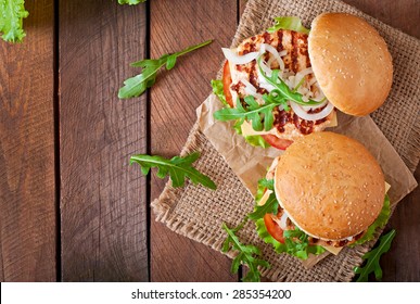 Sandwich With Chicken Burger, Tomatoes, Cheese And Lettuce. Top View