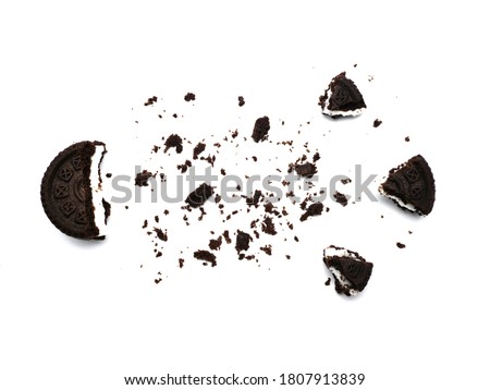 Sandwich chocolate cookies with a sweet cream with crumbs isolated on white background.   