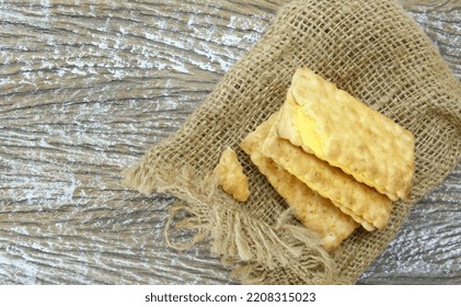 sandwich crackers with cream above sack bag on wood table - Shutterstock ID 2208315023