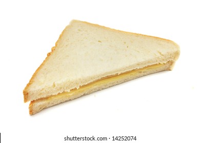A sandwich cut into triangle shape over white background.
