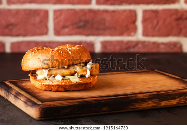 Sandwich. Fast food. Burger with meat and\
vegetables. Black\
burger.