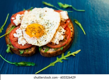 Sandwich With Feta Cheese And Tomatoes, Fried Eggs For Breakfast. Dark Background, Top View